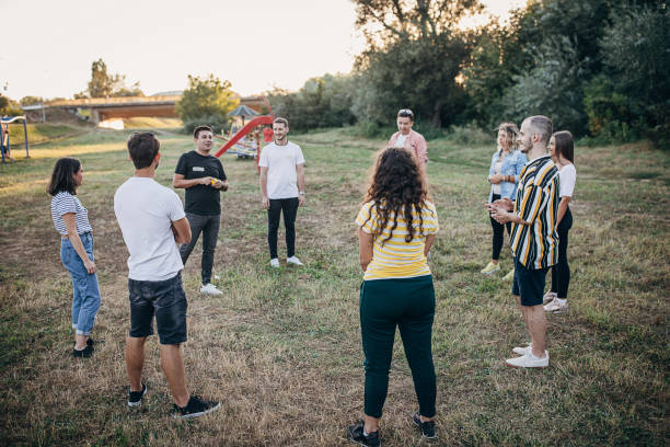 istock Young people making team training exercise during team building seminar outdoors 1273193180