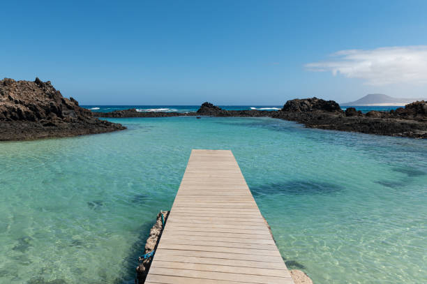 Wooden pier in  Isla de Lobos, Canary Islands, Spain. Wooden pier in  Isla de Lobos, near Fuerteventura, Canary Islands, Spain. point lobos state reserve stock pictures, royalty-free photos & images