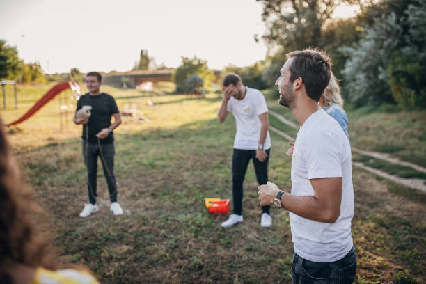 istock Young people playing games on a team building seminar at public park 1273194168