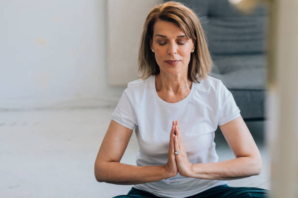 istock Senior Woman Meditating at Home, Self Isolation Concept 1273197932
