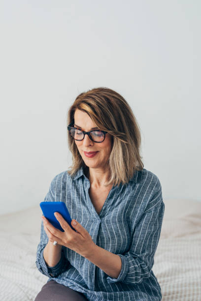 istock Happy Senior Woman Using a Smartphone at Home 1273197982