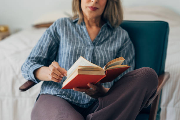 istock Senior Woman Reading a Book at Home 1273197991