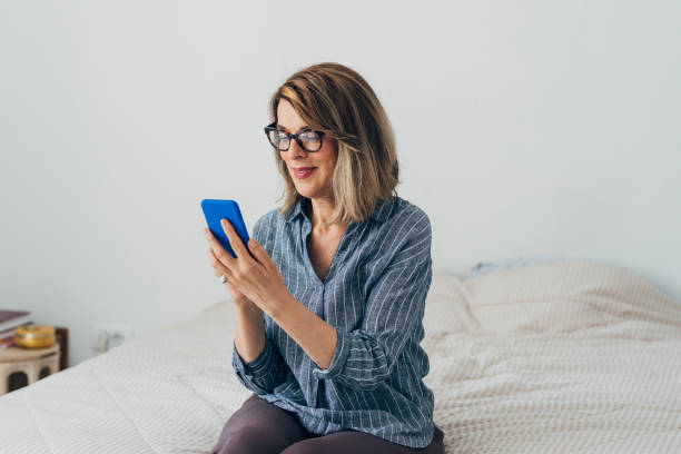istock Happy Senior Woman Using a Smartphone at Home 1273198024