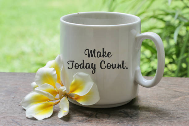 istock Make today great. Morning coffee concept with flower and text message on white cup on the table. 1273198568