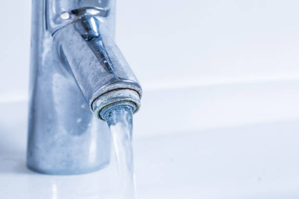istock Faucet flowing water and with limescale. 1273202723