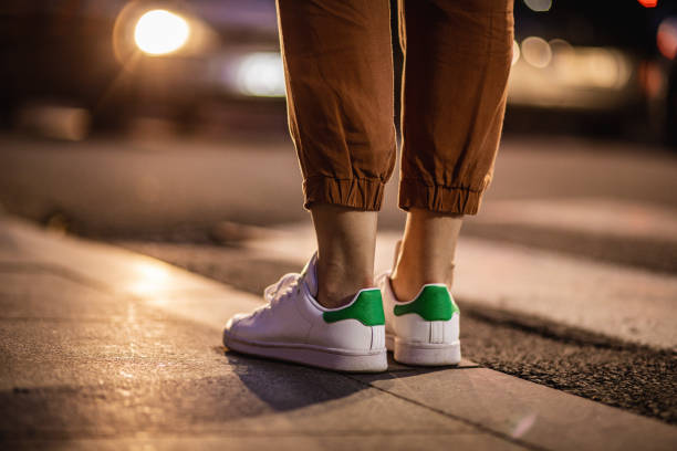 istock Close up human legs walking on the crosswalk 1273202749