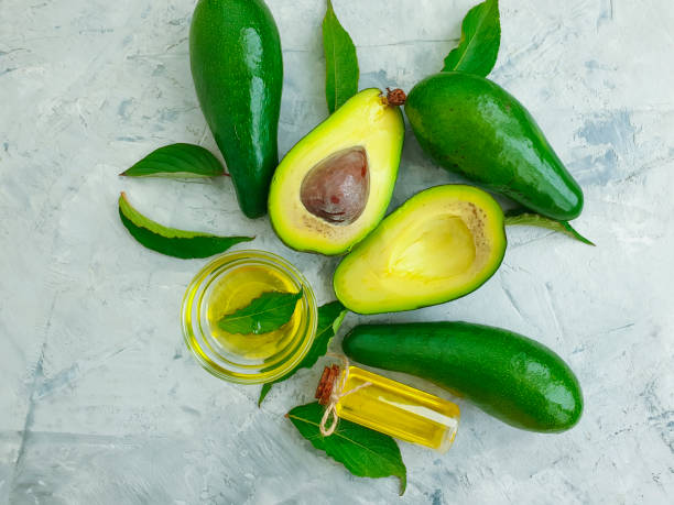 istock fresh avocado, oil on concrete background 1273203582