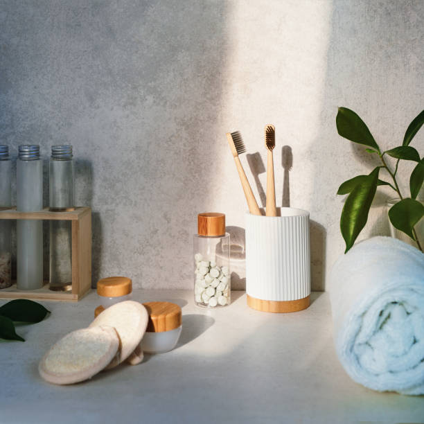 istock Zero waste bathroom items. Bamboo toothbrushes, natural mouth washing tabs, towel, loofah face pads and creams. Hard sunlight and shadow. Natural beauty essentials. Eco-friendly self-care. Square card 1273206239