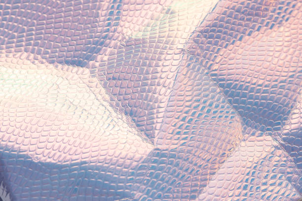 istock Blurred light rainbow crumpled holographic background. 1273206281