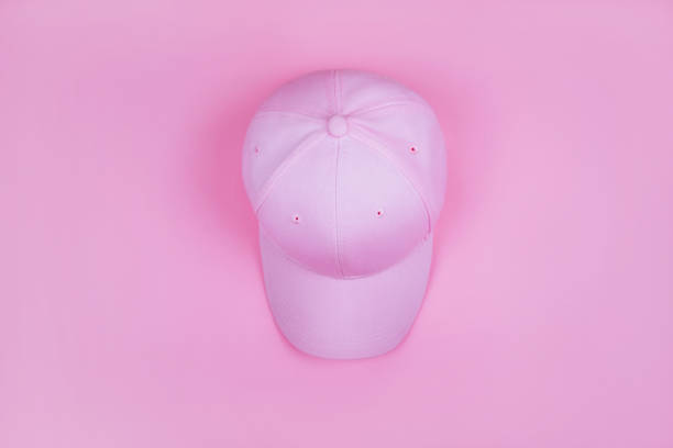 Summer fashion flatlay with cap isolated on pink background.