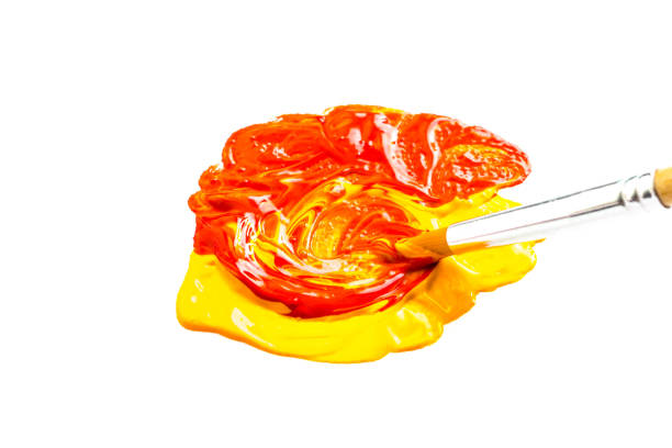 istock Paintbrush mixing Red and Yellow 1273207256