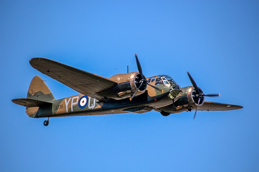 Avro Lancaster heavy bomber, Bournemouth, England. This four-engine bomber aircraft in flight over open sea with cumulus cloud formation in blue sky was the mainstay of bomber command in WW2