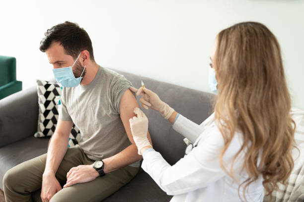 istock Doctor cleaning patient's arm for a vaccine 1273213667