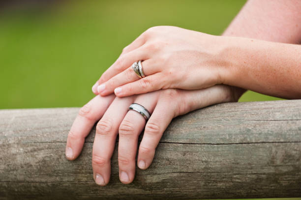 istock Bride and Groom Hands with Wedding Rings 1273213790