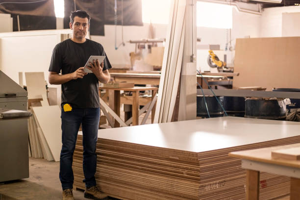 istock Carpenter at the carpentry holding a digital tablet 1273215316