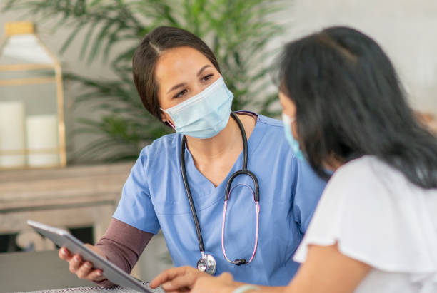 istock Visiting nurse with patient in her home 1273215342