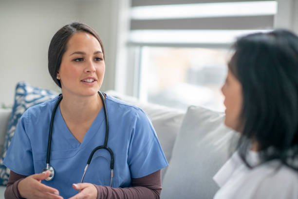 istock Visiting nurse with patient in her home 1273215349