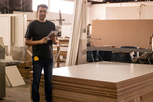 istock Carpenter at the carpentry holding a digital tablet 1273215413