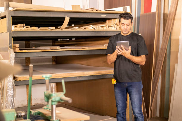 istock Carpenter at the carpentry holding a digital tablet 1273215512