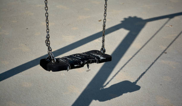 пустые черные качели и его тень - swing playground empty abandoned стоковые фото и изображения