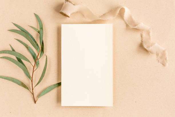 istock Mockup invitation, blank greeting card and green leaves eucalyptus. Flat lay, top view 1273217869