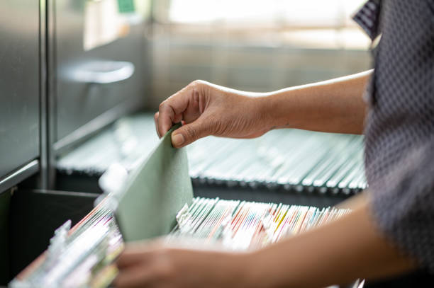 istock Woman's hand searching for documents at the filing cabinet 1273218146
