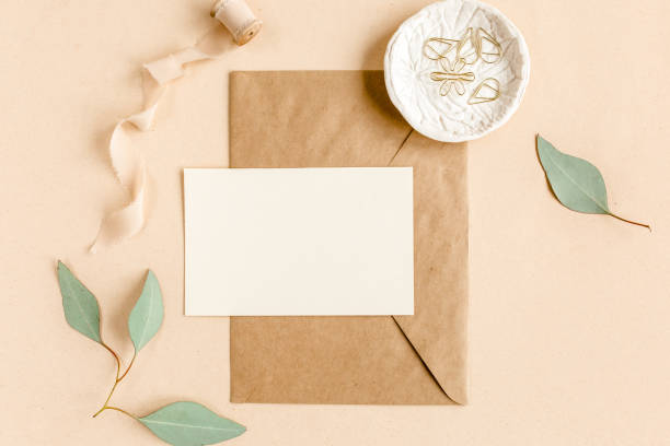 istock Mockup invitation, blank greeting card and craft envelope, green leaves eucalyptus. Flat lay, top view 1273218215