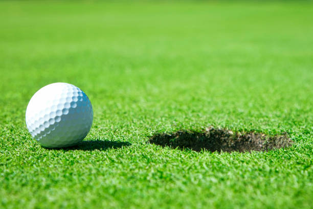 istock Golf Ball By Edge of Hole Close Up. 1273220734