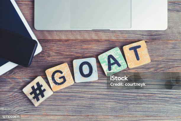 Goat Greatest Of All Time Acronym Laptop Digital Tablet And Mobile Phone With A Hashtag And The Letters Goat Beside Them Stock Photo - Download Image Now