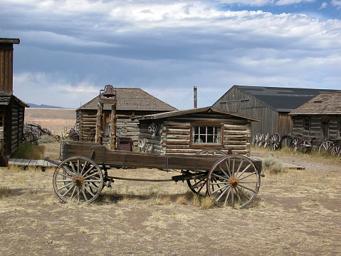 3D illustration rendering of an empty street in an old wild west town with wooden buildings.