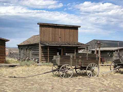 Old western style horse drawn wagons lined up in front of old western buildings,

Taken in Cody, Wyoming, USA.