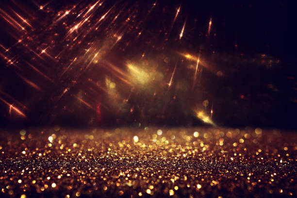 istock background of abstract gold and black glitter lights. defocused 1273226151