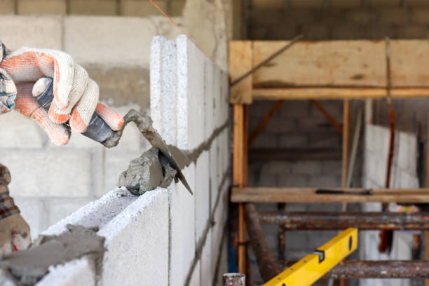 istock The hands of professional construction assistants lay bricks at the construction site. Labor concept. 1273226209