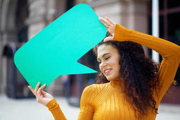 istock Young woman holding a chat bubble 1273229482