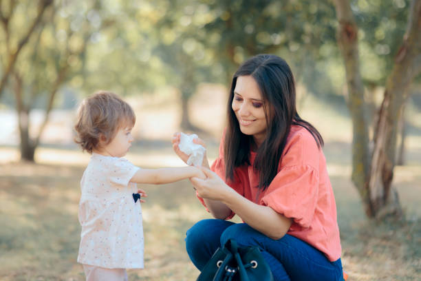 istock Mother Cleaning Her Daughter Hands with Antibacterial Wipes 1273229536