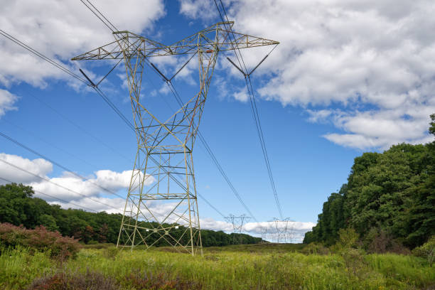 High Power Lines Carrying Electricity For Distribution Through Energy Grid stock photo