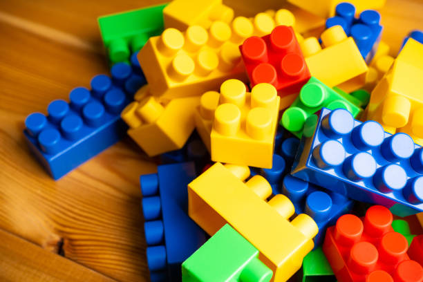 istock Plastic toy blocks different colours on the wooden table 1273232944