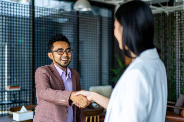 istock Asian Business team doing a business hand shake. 1273233387