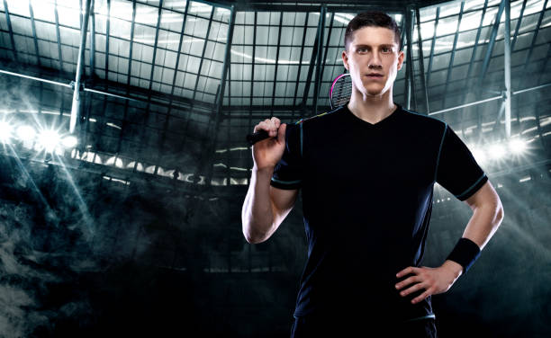 istock Badminton player in sportswear with racket and shuttlecock on stadium. 1273234013