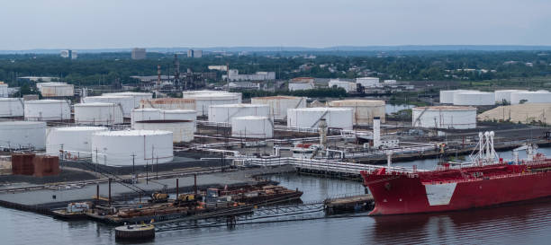 istock Closeup elevated view on the industrial cargo ship unloading at the petroleum terminal in New Jersey, on the Arthur Kill tidal strait at the border with New York State. High resolution aerial stitched panorama. 1273234242