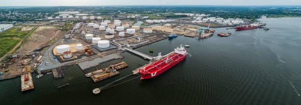 istock Drone elevated view on the industrial cargo ship unloading at the petroleum terminal in New Jersey, on the Arthur Kill tidal strait at the border with New York State. High resolution aerial stitched panorama. 1273234243
