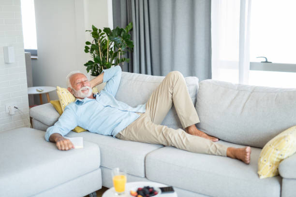 istock Happy senior man relaxing on sofa 1273235046