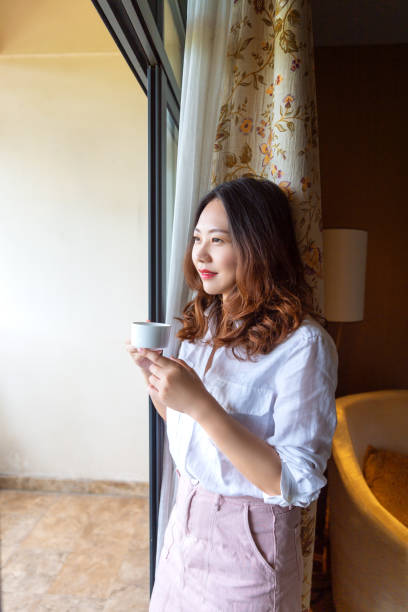istock A girl is drinking coffee on the balcony 1273237628