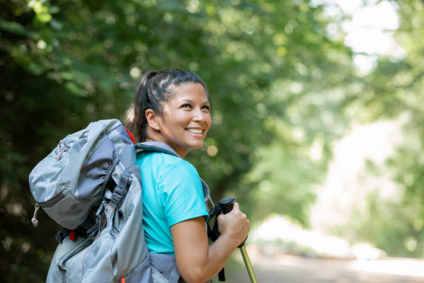 istock Woman smiles while hiking in forest 1273239547