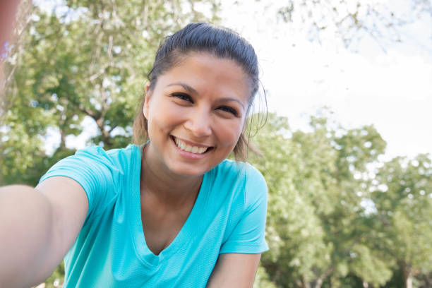 istock Young woman smiles while taking selfie 1273239555