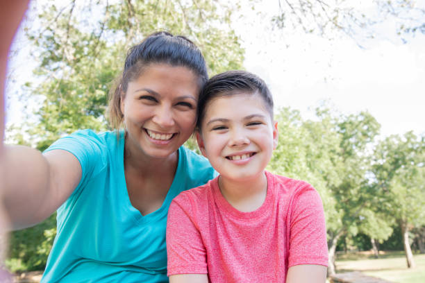istock Young boy and his mom take selfie together 1273239562