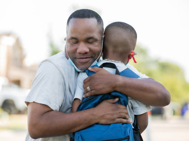 istock Father embraces son on the first day of school 1273241324