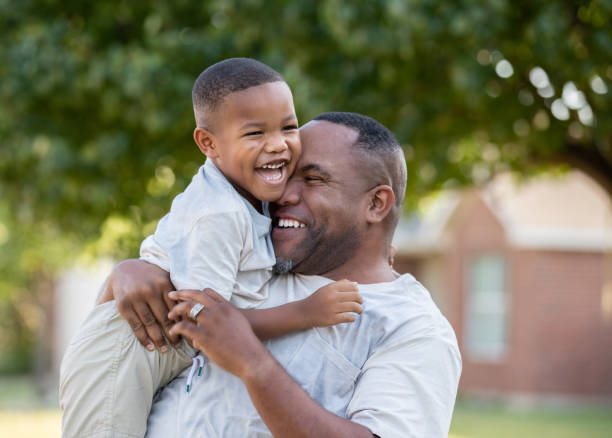 istock Father and son hugging each other while playing outdoors 1273241325
