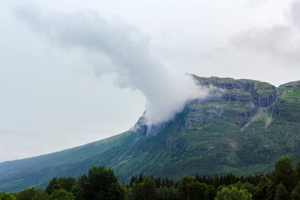 Double Hydnefossen waterfall shrouded in incredible clouds and fog in Hemsedal, Viken Buskerud in Norway.
