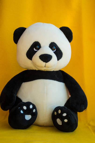 istock soft toy panda on yellow background 1273249542